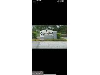 Sign for Camelot Club Condominiums amidst lush landscaping and trees at 1308 Camelot Dr, South Fulton, GA 30349