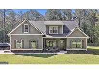 Charming home featuring a manicured lawn, inviting front porch, and a harmonious blend of siding textures at 211 Beavers Rd, Grantville, GA 30220