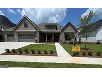 Charming craftsman-style home with well-manicured lawn, attached two-car garage, and inviting front porch at 317 Ruffian Cir # 72, Peachtree City, GA 30269