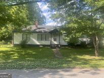 Charming one-story home with lush trees and a well-manicured lawn, offering great curb appeal at 4109 Francis Ne St, Covington, GA 30014