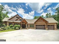 Stunning home with three-car garage, stone accents, and professional landscaping creates an inviting curb appeal at 177 Selfridge Rd, Mcdonough, GA 30252