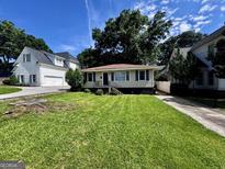 Charming single-story home with a well-maintained lawn and mature trees, set in a peaceful neighborhood at 1511 Walker Ave, Atlanta, GA 30337