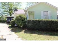 Charming home with a well-maintained lawn and a convenient carport at 905 Ohara Dr, Jonesboro, GA 30236