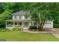 Charming two-story home with a welcoming front porch and beautifully landscaped front yard at 4645 Villa Ridge Ne Rd, Marietta, GA 30068
