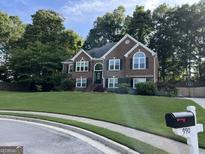 Charming two-story brick home with landscaped front yard and inviting curb appeal at 990 Fountain Glen Dr, Lawrenceville, GA 30043