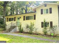 Charming home featuring a well-maintained yard, a light brick facade, and stylish shutters at 481 Meadowbrook Se Dr, Marietta, GA 30067