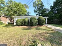 Ranch-style home featuring an expansive front yard with mature landscaping at 2103 Keheley Dr, Decatur, GA 30032
