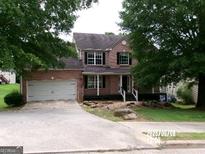 Charming two-story brick home with a front-facing garage and landscaped yard at 2225 Blue Ridge Ln, Conyers, GA 30012