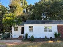 Charming single-story home featuring a white facade, landscaped yard, and inviting front entrance at 1764 Cahoon Sw St, Atlanta, GA 30310