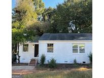 Charming single-story home featuring a freshly painted white exterior at 1764 Cahoon Sw St, Atlanta, GA 30310
