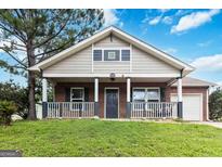 Charming single-Gathering home featuring a welcoming front porch and well-maintained lawn at 1147 Dunivin Dr, Jonesboro, GA 30238