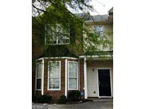 Traditional-style home with red brick and beige siding, black front door, and professionally monitored security system at 11313 Michelle Way, Hampton, GA 30228