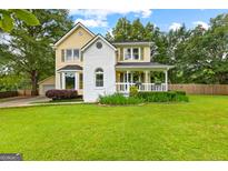 Charming two-story home with a lush front lawn and inviting front porch at 135 Cherokee Pl, Fayetteville, GA 30215