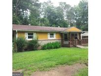 Charming single-story home with a welcoming front porch and a well-maintained lawn at 5420 Herndon Blvd, Morrow, GA 30260