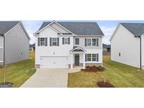 Charming two-story home featuring white siding, dark shutters, and a well-manicured lawn at 1628 Palladian Dr, Lithonia, GA 30058