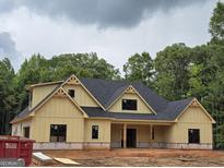 Charming new home featuring a craftsman-style exterior with yellow siding and black windows at 365 Spruill Bridge Road # 7 - Helmsley Park, Temple, GA 30179