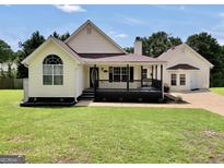 Charming single-story home with well-manicured lawn, covered porch, and welcoming curb appeal at 250 Stallsworth Rd, Mcdonough, GA 30252