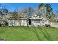 Charming single-story home with a well-manicured lawn and inviting front entrance at 4385 Midway Rd, Douglasville, GA 30134