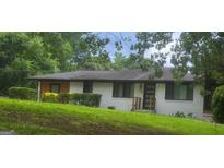 Charming single-story home with painted white brick and well-maintained lawn and landscaping at 4916 Campbellton Sw Rd, South Fulton, GA 30331