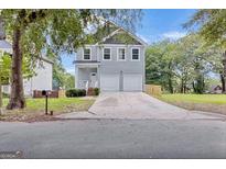 Charming two-story home with a well-manicured front yard and a two-car garage at 583 Whitaker Nw St, Atlanta, GA 30318