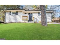 Charming single-story home featuring a freshly painted brick exterior and a well-manicured lawn at 2327 Scotty Cir, Decatur, GA 30032