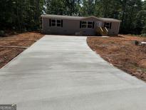 Newly poured concrete driveway leads to a charming single-Gathering home in a wooded setting at 436 Laurel Trce, Carrollton, GA 30116