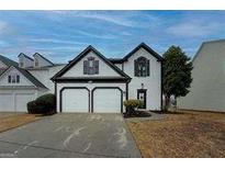 Charming home with a two-car garage and well-manicured lawn, offering great curb appeal at 2587 Alvecot Cir, Atlanta, GA 30339