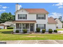 Charming two-story home with a well-manicured lawn and inviting front porch, enhancing its curb appeal at 7770 Hana Court Ct, Jonesboro, GA 30236