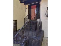 Charming front entrance with brick steps, decorative iron railings, and a striking red front door at 5840 Butner Rd, South Fulton, GA 30349