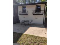 The patio area offers a relaxing outdoor space with a table and chairs for enjoying the surroundings at 5840 Butner Rd, South Fulton, GA 30349
