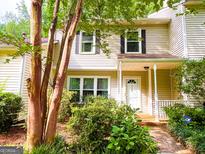 Charming townhome with a covered front porch and neatly landscaped yard at 3150 Stratford Green Pl, Avondale Est, GA 30002