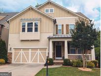 Charming two-story home boasts a well-manicured lawn and a welcoming front porch with stone accents at 1840 Tululah Trl, Smyrna, GA 30082