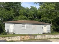 Two unit home featuring a brick facade, offering classic charm and potential at 1419 Cleveland Ave, Atlanta, GA 30344