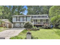 Charming home with stone accents, a front porch, and manicured lawn at 9138 Sunset Dr, Jonesboro, GA 30238