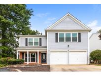 Two-story home with a two-car garage, black shutters, and a well-maintained front yard at 2801 Priestcliff Dr, Smyrna, GA 30080
