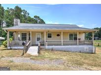 Charming ranch-style home featuring a covered front porch, and a well-maintained lawn at 668 Spring Place Ne Rd, White, GA 30184