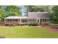 Charming brick home with manicured lawn and mature trees offering great curb appeal at 2179 Mountclaire Ct, Stone Mountain, GA 30087