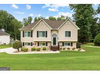 Charming two-story home featuring manicured lawn and inviting front entrance at 345 Wynbrook Dr, Mcdonough, GA 30253