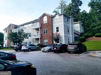 Charming apartment complex featuring brick accents, well-maintained landscaping, and ample parking spaces at 1392 Orchard Park Dr, Stone Mountain, GA 30083
