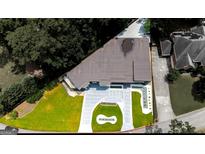 Stunning aerial view of a modern home featuring a manicured lawn and stylish circular driveway at 2401 Ne Greenglade Rd, Atlanta, GA 30345