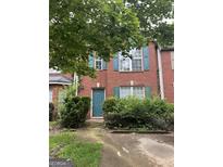Charming red brick townhouse with teal shutters and a well-maintained front yard at 2756 Norfair Loop, Lithonia, GA 30038