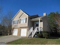 Charming two-story home with attached two-car garage and well-maintained front lawn at 5400 Twin Lakes Dr, South Fulton, GA 30349