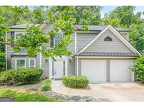 Charming two-story home with a well-manicured lawn and attached two-car garage at 4959 Abbotts Glen Nw Trl, Acworth, GA 30101