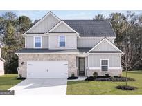 Charming two-story home featuring a brick facade, grey siding and a well-manicured lawn at 3373 Arabian Farm Dr, Dacula, GA 30019