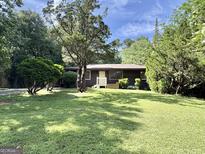 Charming single-story home featuring a well-maintained lawn and mature landscaping at 10173 Brass Ring Rd, Jonesboro, GA 30238