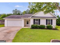 Charming single-story home with white siding, a two-car garage, and well-maintained landscaping at 102 Natalie Ct, Dallas, GA 30157