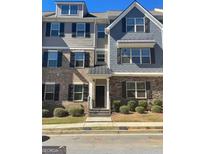 Stylish townhome featuring a welcoming front entrance with stone and siding accents and well-maintained landscaping at 3810 Equity, Powder Springs, GA 30127