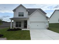 Charming two-story home features a two car garage and well manicured lawn at 422 Cantrell Drive, Dallas, GA 30157