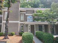 Exterior view of a two-story unit featuring nice landscaping with green bushes and a walkway at 17 Brittany Ne Way, Atlanta, GA 30324