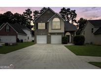Charming two-story home boasts a brick facade, two-car garage, and well-manicured lawn at 120 Hawken Trl, Mcdonough, GA 30253